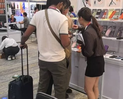 Sales team introducing custom mobile accessories and phone cases to a buyer