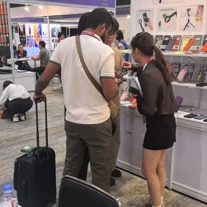 Sales team introducing custom mobile accessories and phone cases to a buyer